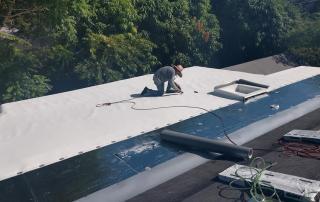 Parlament roofing worker installing TPO on roof