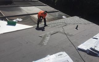 Parlament worker installing gray shingles